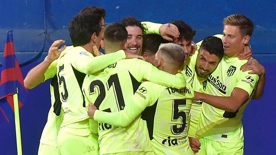 Suarez double fires Atletico seven points clear